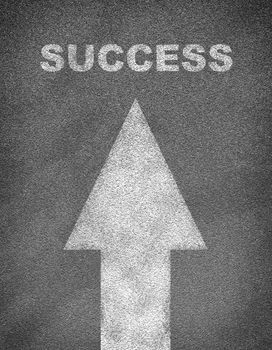 Asphalt road texture with arrow and word success. Business concept