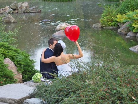 happy newlyweds in japanese garden