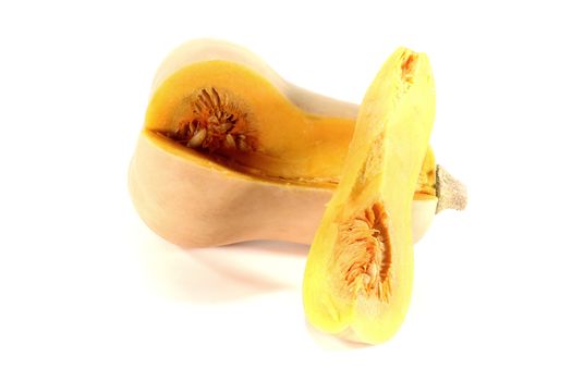 Butternut squash with a quarter on light background