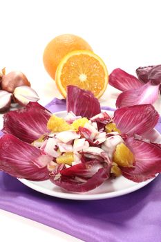 red chicory salad with orange slices and dressing