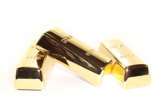 three stacked gold bars on a light background