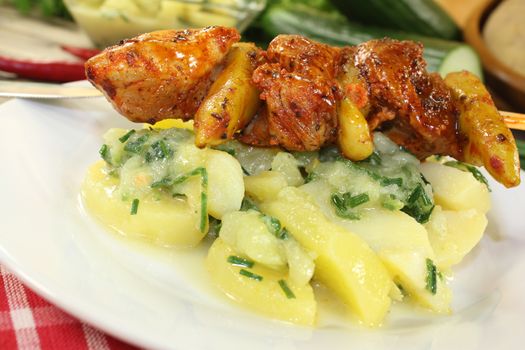 Potato-cucumber salad with fiery fire skewers and parsley