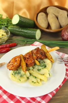 Potato-cucumber salad with fire skewers and parsley