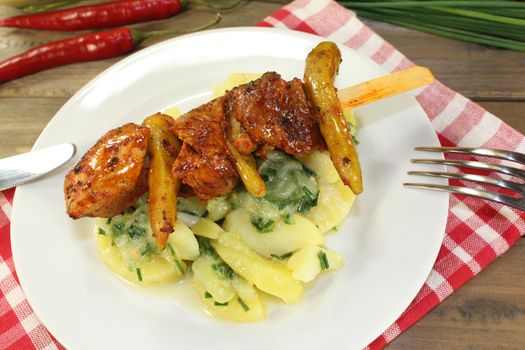 Potato-cucumber salad with fiery grilled fire skewers and parsley