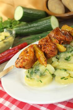 Potato-cucumber salad with grilled fire skewers and parsley