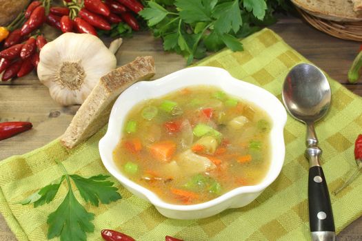 Chicken consomme with greens, chilli and bread