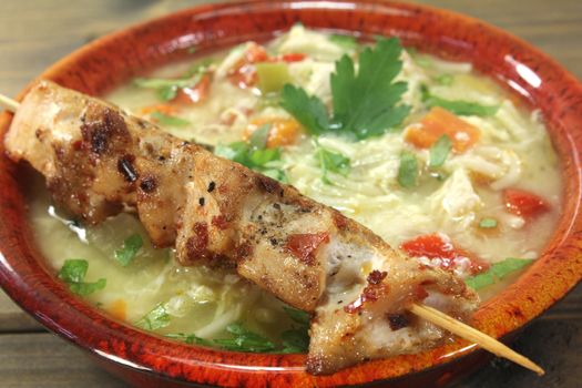 Chicken soup with greens, parsley and bread