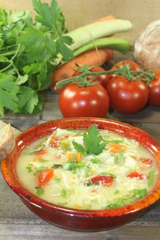 Chicken soup with greens, parsley and bell pepper