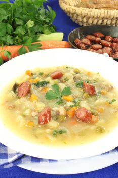 Hearty cabbage soup with Mettwurst sausage and greens