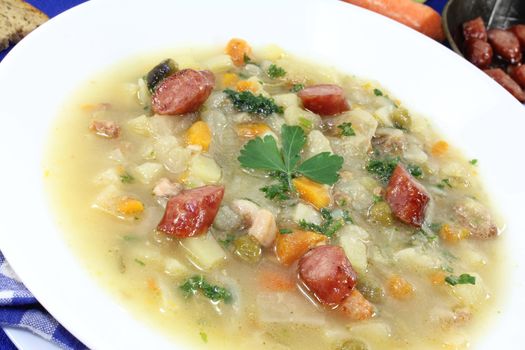 hot hearty cabbage soup with Mettwurst sausage and greens