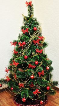 beautiful home Christmas Tree in red and gold colors 