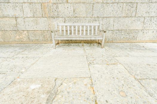 wooden park bench camouflaged by surrounding concrete blocks