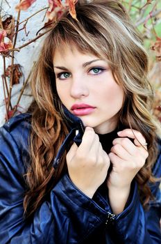 portrait of eye-catching girl wering leather jacket 