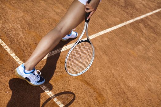 Girl playing tennis on the court