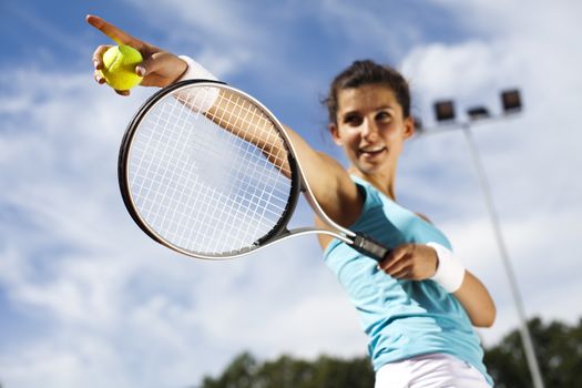 Young woman playing tennis, summertime saturated theme