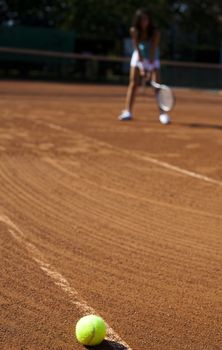 Young woman playing tennis, summertime saturated theme