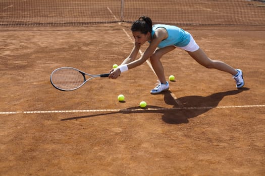 Young woman playing tennis, summertime saturated theme