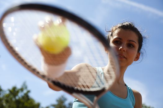 Girl playing tennis on the court