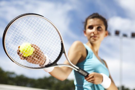 Young woman tennis player on the court