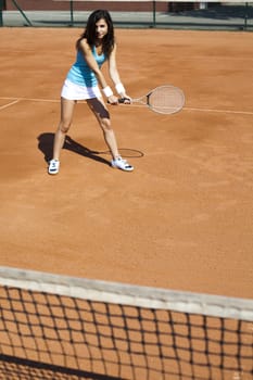 Young woman tennis player on the court
