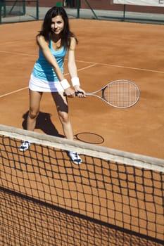 Young woman tennis player on the court