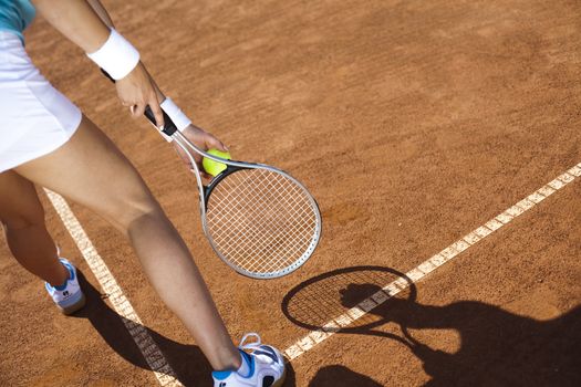 Young woman tennis player on the court