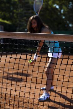 Girl playing tennis on the court