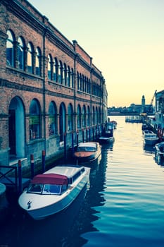 One of the canals of Murano used as boats parking, Venice, Italy