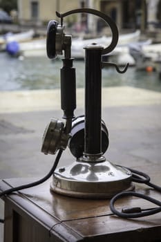 An old telephone of the first years of the XX century exposed outside the bay of Lake of Garda, Italy