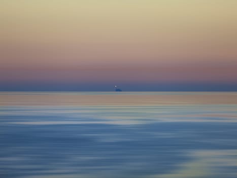 Ripples and motion waves move slowly around a distant oil platform 