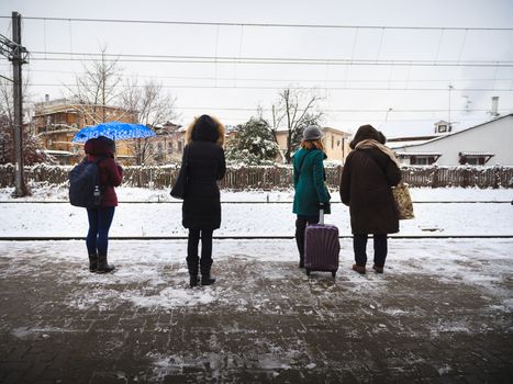 Four women with totally different styles are waiting for the train in Monza, Italy