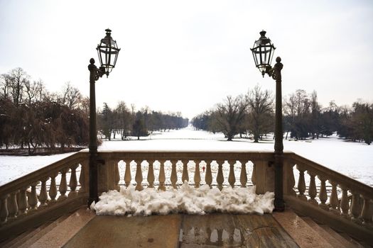 A snowy luxury balcony with a huge park covered by snow, Monza, Italy