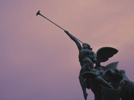 Statue of an winged angel playing the victory with its trumper, Monza, Italy