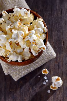 Pop corn in a bowl on a wooden table