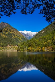 mirror lake at Jiuzhaigou scenic area with mountain snow, Sichuan, China