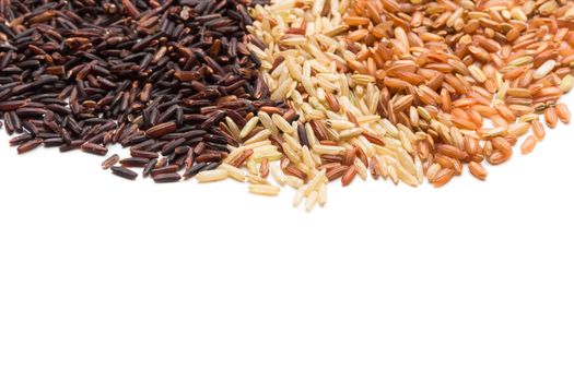 Three variety kinds of brown rice, black ,yellow and brown with copy space