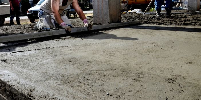 Picture of a worker concreting the floor