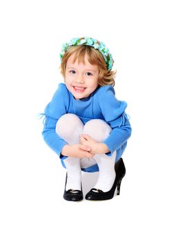 happy little girl wearing mother's shoes
