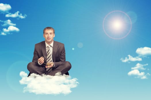 Businessman sitting in lotus position on cloud, holding golden lamp of Aladdin. Sky with sun as backdrop