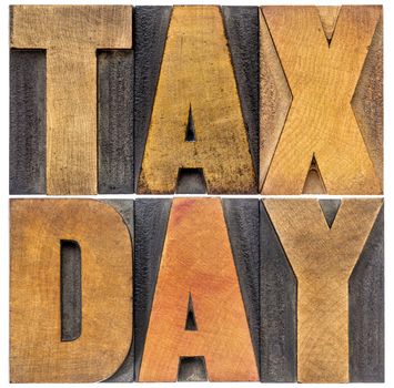 tax day word abstract in letterpress wood type - financial concept