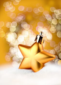 Golden Christmas decoration star on bokeh background
