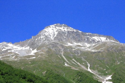 Caucasus Mountains Under Snow And Clear Blue Sky