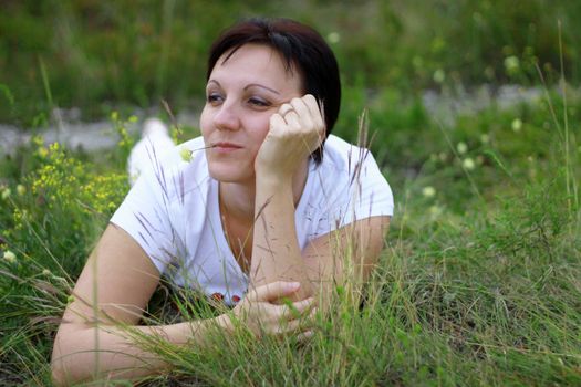 Woman laying in the grass on the meadow