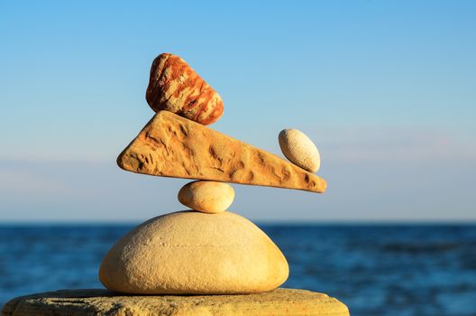 Balancing of pebbles on the stone at the seashore