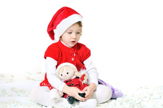 little santa helper sitting with doll