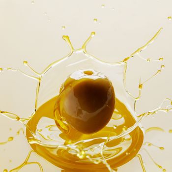 Splash of olive fruit in oil close-up view