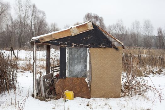 Temporary self-made shelter covered with the snow in winter.