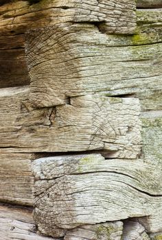 The corner of the old log house. Close up. Wooden texture.