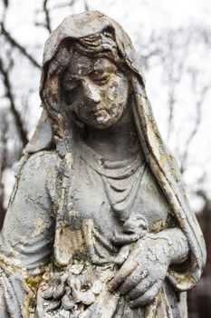 Old cemetery marble sculpture of the young girl.