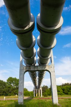 Elevated section of the pipelines with the concrete support against the sky